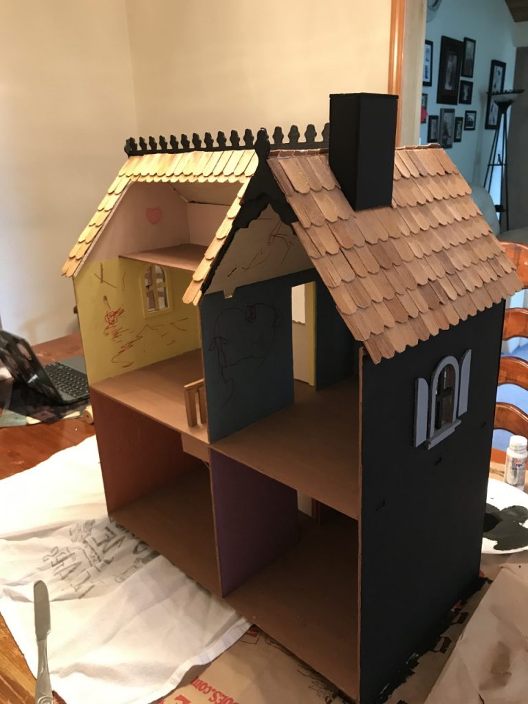 Paint an old dollhouse to make it creepy